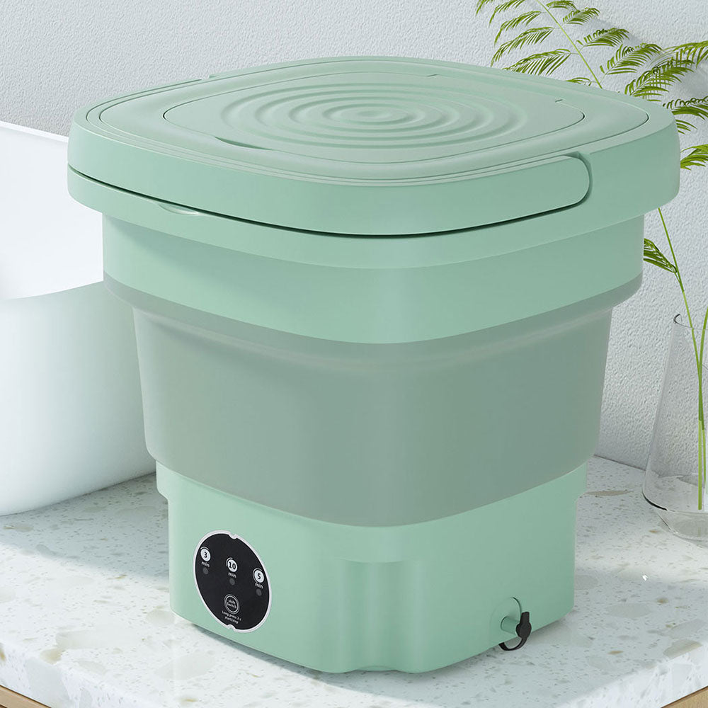 Devanti 8 L portable foldable washing machine in green on a bathroom bench