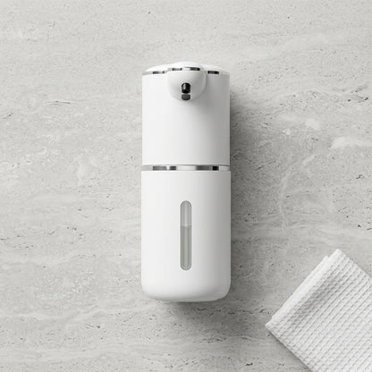 White soap dispenser on a gray concrete wall